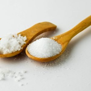 Salt,And,Sugar,On,Small,Wooden,Spoon,On,White,Background